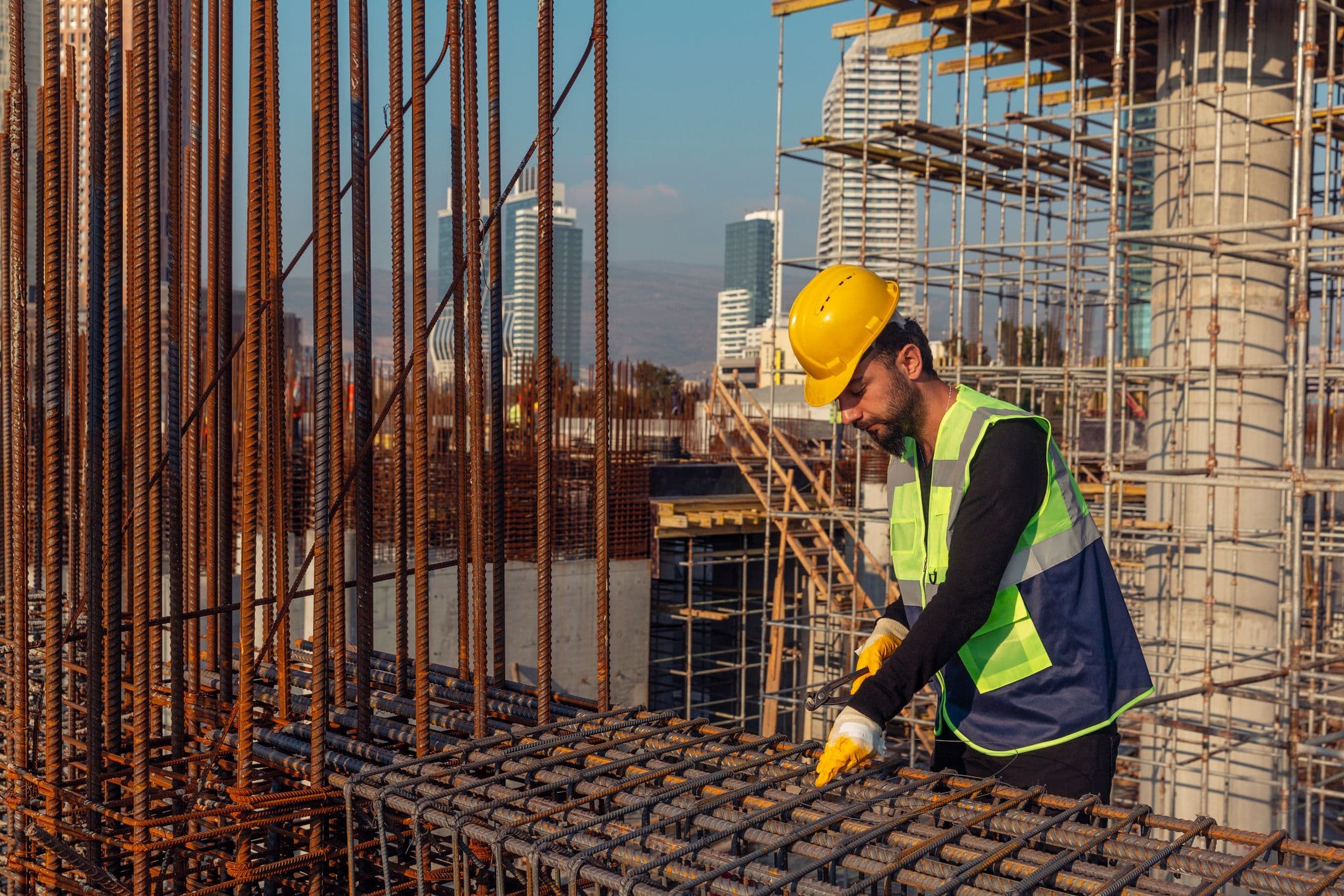 Building Worker Pointing at Construction Crane